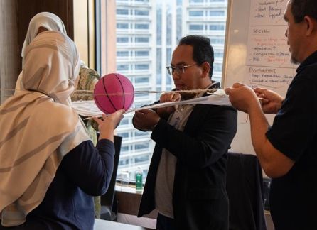 Two teams building linked bridges in Penang Bridge of Excellence and Unity