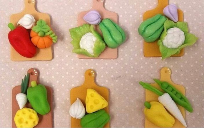 Handmade clay ingredients laid out on wooden boards for Restaurant Rush